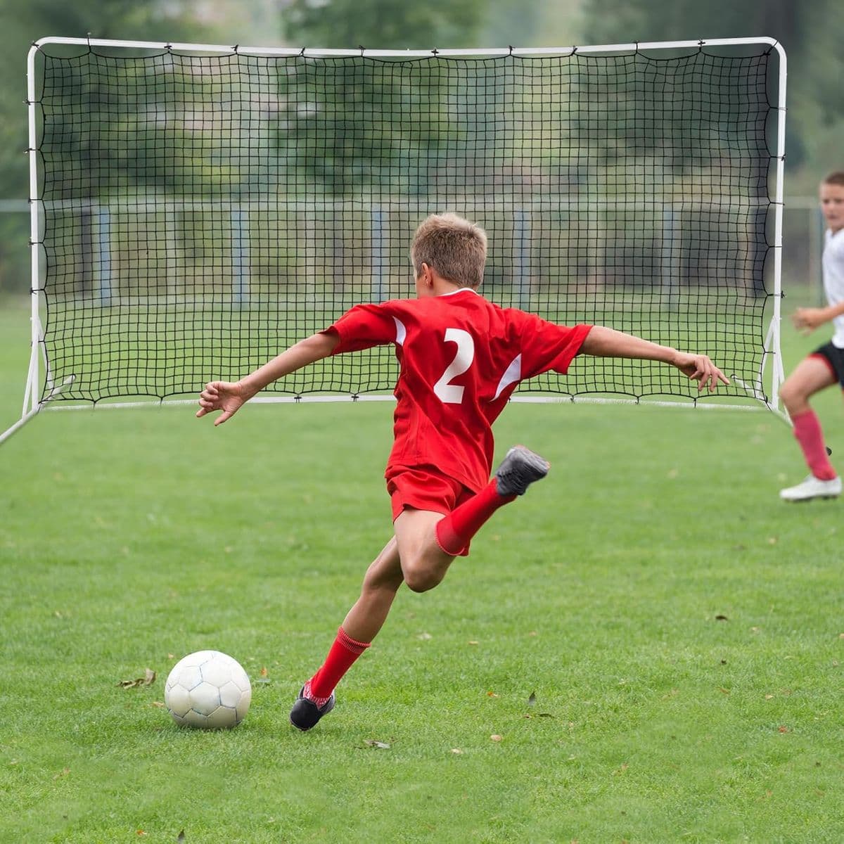 Young soccer player with ball